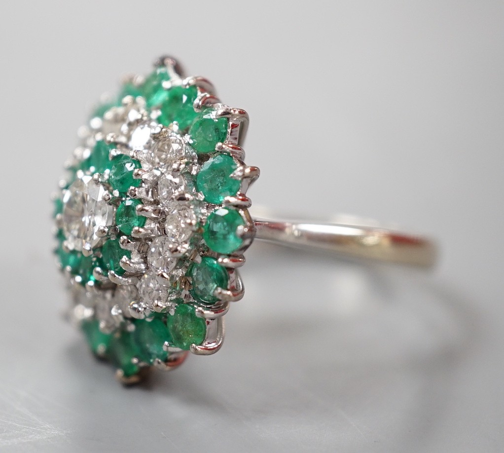A modern 18ct white gold emerald and diamond cluster set dress ring, (emerald missing), size J, gross weight 6.9 grams.